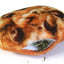 Close-up of the refillable catnip pocket in the Meowijuana cookie toy, slightly filled with loose catnip.