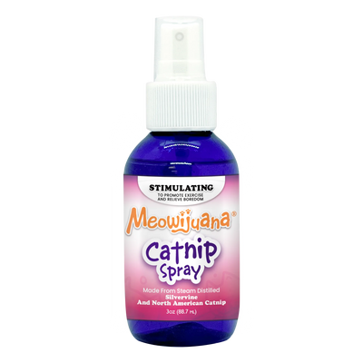 A bottle of Meowijuana Catnip Spray with a purple label, labeled as stimulating for exercise and boredom relief, 3 oz size.