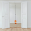 An orange squid catnip toy hangs from a door jamb clip in a bright, empty room with white doors and wood flooring, ready for cat playtime.